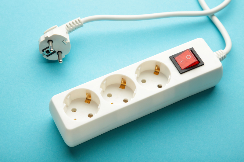 Electric white portable socket on blue background